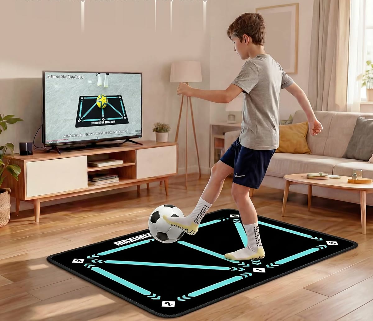 Young player following a football lesson on the TV while practicing on the training mat